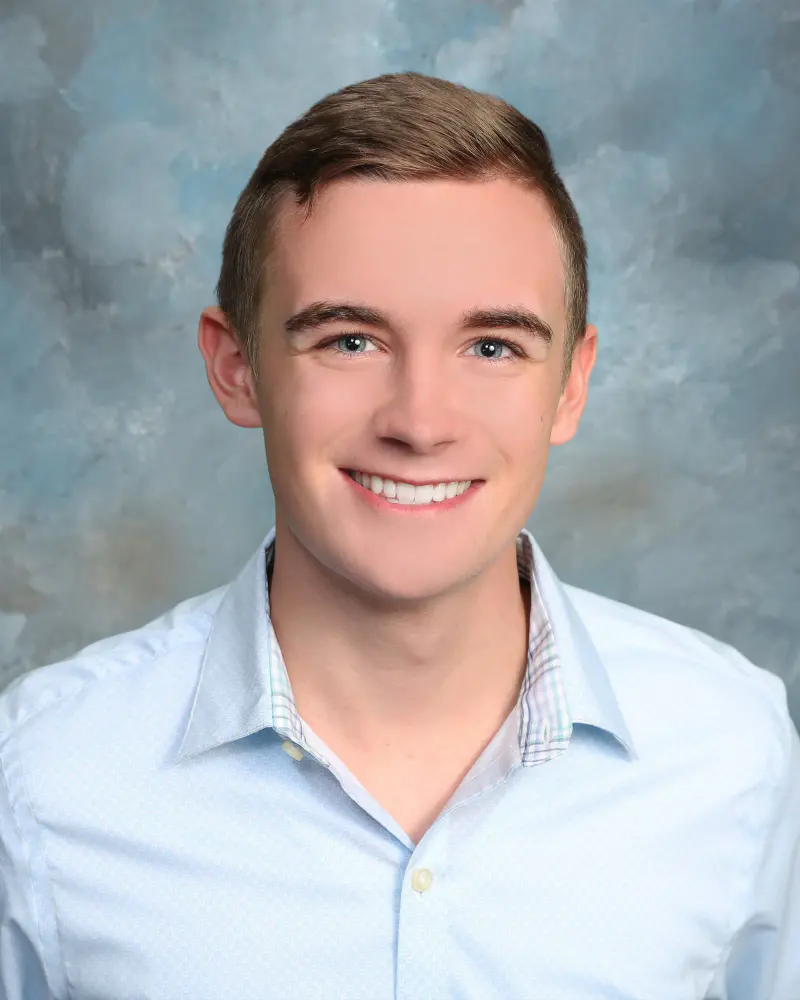 Student portrait on a blue backdrop