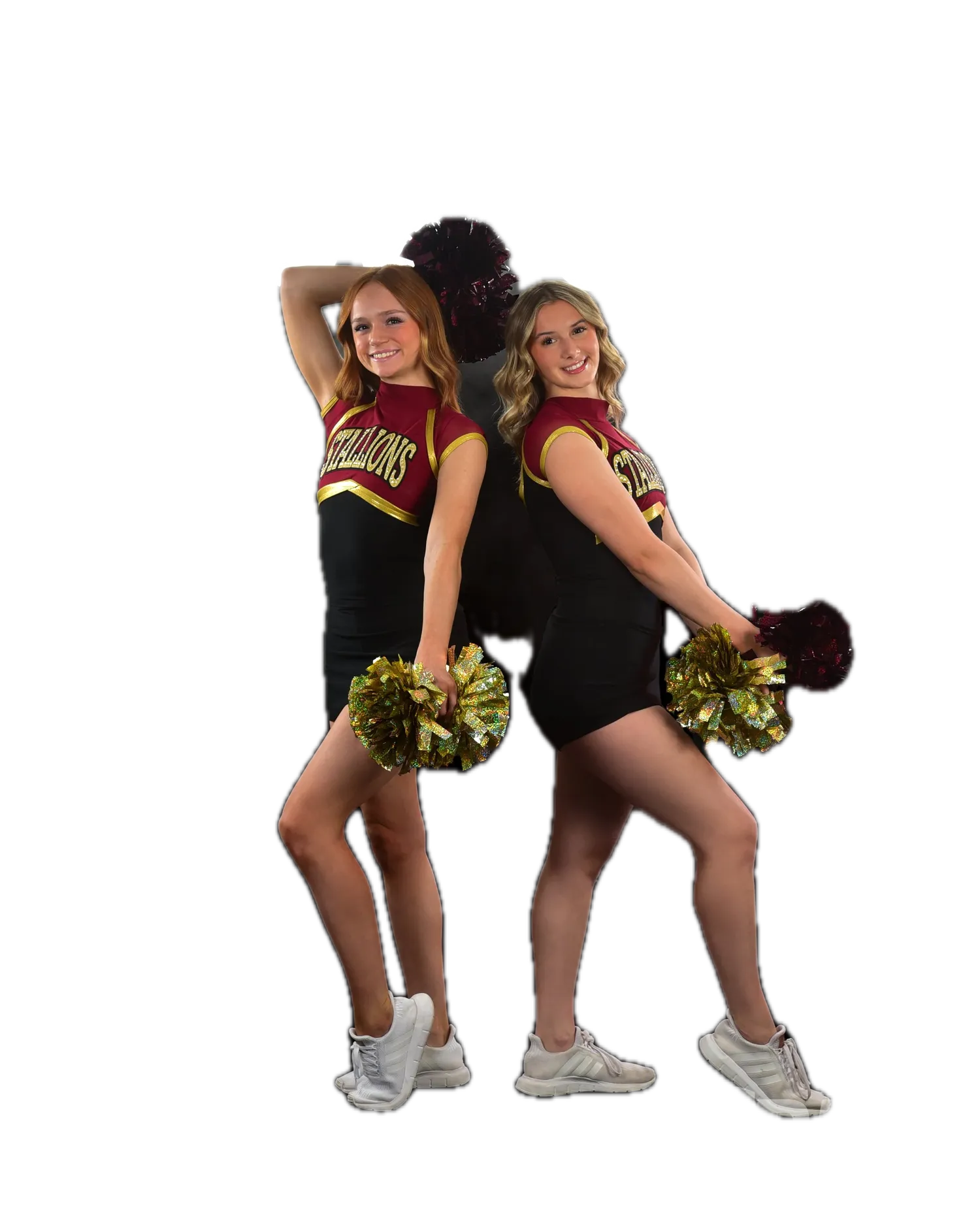 Two cheerleaders in maroon/black/gold uniforms posing back-to-back with gold pom-poms in front of a grid of round stadium-style lights with haze
