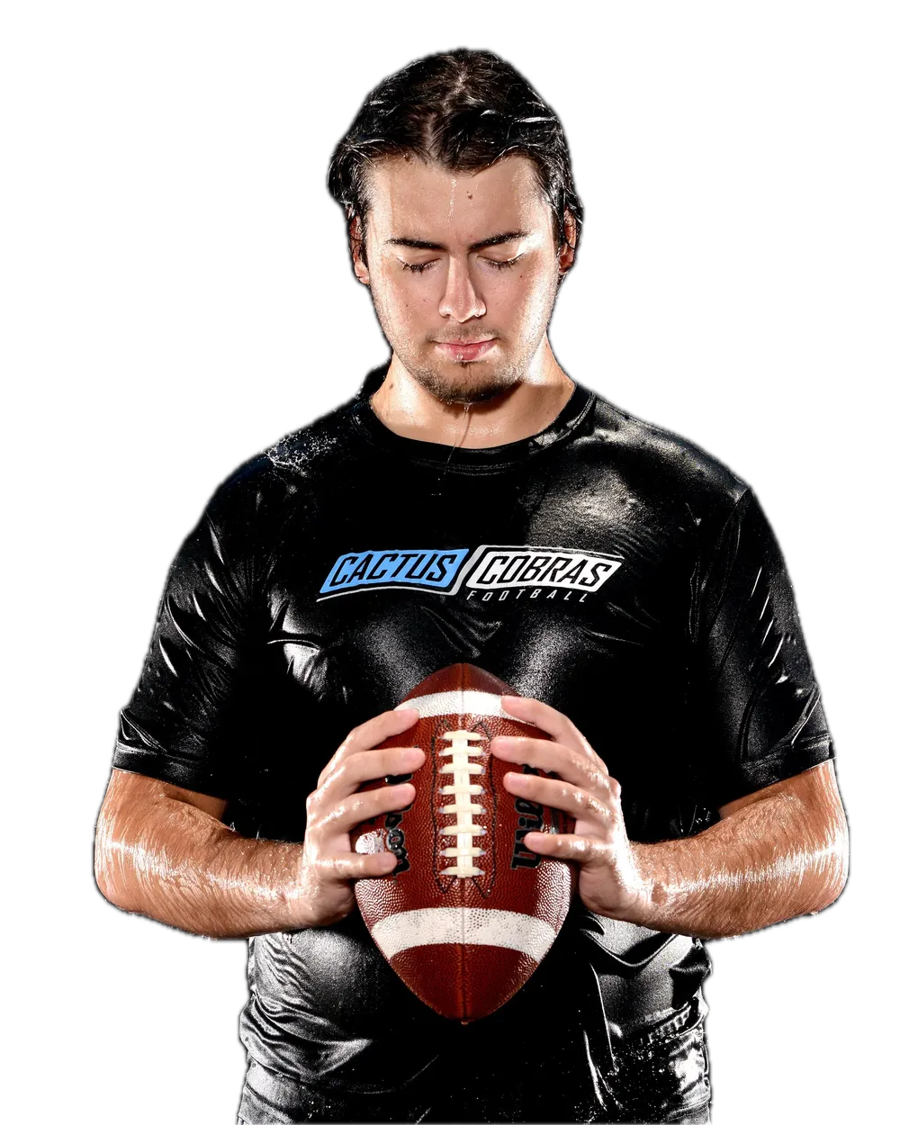 Football player holding the ball under falling water